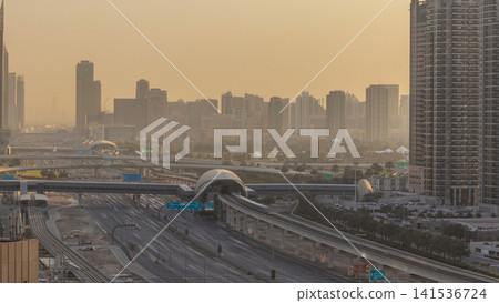 Aerial view of Jumeirah lakes towers skyscrapers during sunrise timelapse with traffic on sheikh zayed road. Aerial view of Jumeirah lakes towers skyscrapers during sunrise timelapse with traffic on sheikh zayed road. 141536724