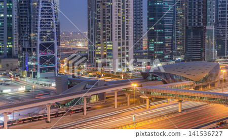 Aerial view of Jumeirah lakes towers skyscrapers day to night timelapse with traffic on sheikh zayed road. Aerial view of Jumeirah lakes towers skyscrapers day to night timelapse with traffic on sheikh zayed road. 141536727
