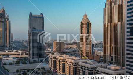 Dubai downtown skyline night to day timelapse and Sheikh Zayed road traffic, UAE Dubai downtown skyline night to day timelapse and Sheikh Zayed road traffic, UAE 141536747