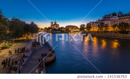 Rear view of Notre Dame De Paris cathedral day to night timelapse after sunset. Rear view of Notre Dame De Paris cathedral day to night timelapse after sunset. 141536763