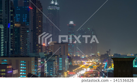 Downtown Dubai towers day to night timelapse. Aerial view of Sheikh Zayed road with skyscrapers after sunset. Downtown Dubai towers day to night timelapse. Aerial view of Sheikh Zayed road with skyscrapers after sunset. 141536826