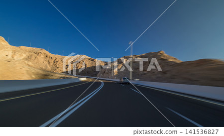 Curvy road through the Jebel Hafeet road timelapse hyperlapse, Al Ain, United Arab Emirates Curvy road through the Jebel Hafeet road timelapse hyperlapse, Al Ain, United Arab Emirates 141536827