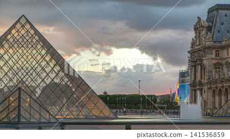 The Louvre museum pyramid at sunset timelapse in Paris, France 141536859