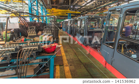 Conveyor assembly stage the body of tractor at big industrial factory timelapse 141536962