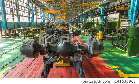 Conveyor assembly stage the body of tractor at big industrial factory timelapse Conveyor assembly stage the body of tractor at big industrial factory timelapse 141536963