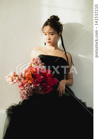 A woman in a black dress A woman in a black dress 141537210