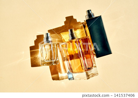Perfume bottles reflecting sunlight and casting shadows Perfume bottles reflecting sunlight and casting shadows 141537406