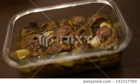 Homemade chicken gizzard confit, a snack served in a storage container. Homemade chicken gizzard confit, a snack served in a storage container. 141537760