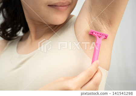 Asian young woman shaving armpit hair clean removal with razor after shower. Asian young woman shaving armpit hair clean removal with razor after shower. 141541298