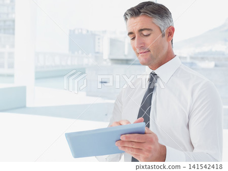 Middle-aged man standing on rooftop holding light blue tablet, white shirt striped tie, copy space Middle-aged man standing on rooftop holding light blue tablet, white shirt striped tie, copy space 141542418