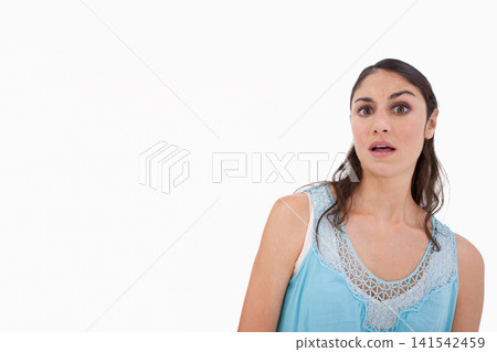 Adult female posing on right against white backdrop, wearing blue top showing surprise, copy space Adult female posing on right against white backdrop, wearing blue top showing surprise, copy space 141542459