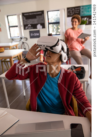 African american teacher and student exploring vr in modern classroom with headset and tablet African american teacher and student exploring vr in modern classroom with headset and tablet 141542469