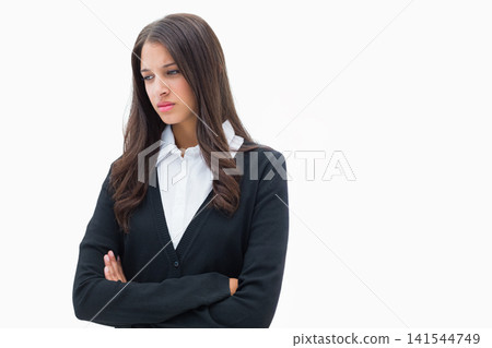 Female standing arms crossed, looking down right on white backdrop, long hair, cardigan, copy space Female standing arms crossed, looking down right on white backdrop, long hair, cardigan, copy space 141544749