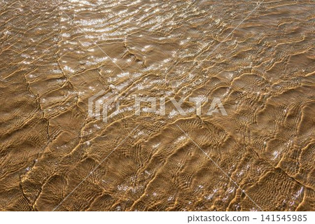 Close-up of cracked dry red clay soil in sunny field Close-up of cracked dry red clay soil in sunny field 141545985