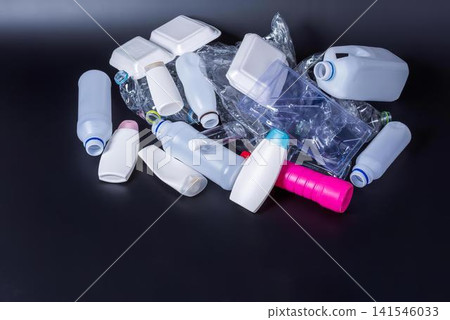 Collection of empty plastic bottles and containers on black surface Collection of empty plastic bottles and containers on black surface 141546033