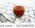 A glass of bright red health drink 141546456