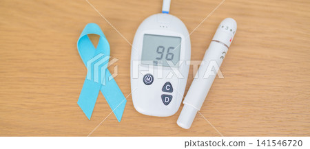 digital blood glucose meter with lancet pen and Blue Ribbon on table. high blood sugar level, November World Diabetes Day, Awareness month, Glycemia,, Hyperglycemia and insulin testing and checking digital blood glucose meter with lancet pen and Blue Ribbon on table. high blood sugar level, November World Diabetes Day, Awareness month, Glycemia,, Hyperglycemia and insulin testing and checking 141546720