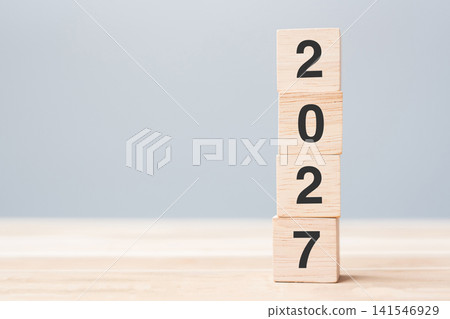 wooden cube block with 2027 text on table background. Resolution, plan, review, goal, start and New Year holiday concepts 141546929