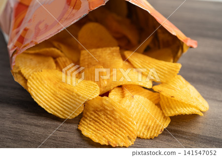 Potato chips delicious BBQ seasoning spicy for crips, thin slice deep fried snack fast food. Potato chips delicious BBQ seasoning spicy for crips, thin slice deep fried snack fast food. 141547052