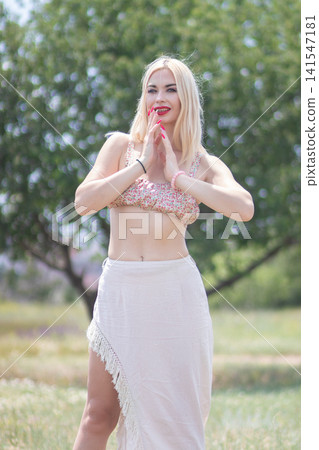 Fashion portrait of one adult woman smiling with hands together near her face in bright sunlight. Great for beauty, happiness, summer style, and lifestyle concepts. Fashion portrait of one adult woman smiling with hands together near her face in bright sunlight. Great for beauty, happiness, summer style, and lifestyle concepts. 141547181