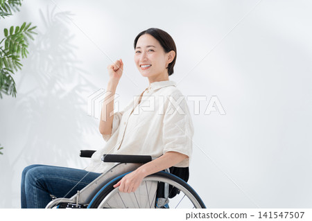 A woman riding a wheelchair A woman riding a wheelchair 141547507