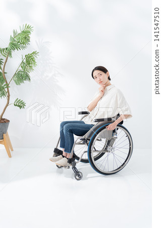 A woman in a wheelchair thinking 141547510