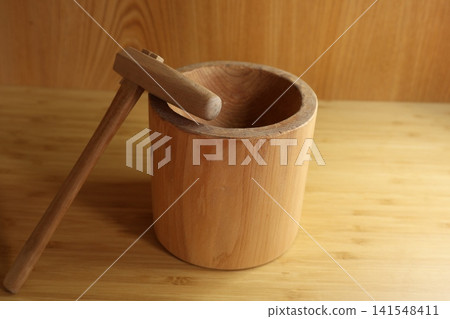 Miniature sculptures of a mortar and pestle Miniature sculptures of a mortar and pestle 141548411