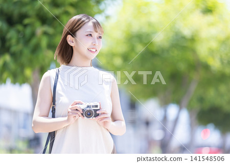 A woman with a camera A woman with a camera 141548506