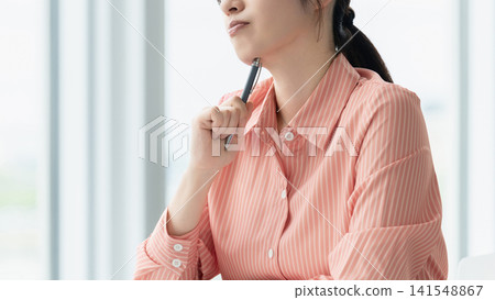 A woman thinking/businesswoman A woman thinking/businesswoman 141548867