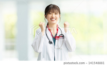 Female medical staff doing a fist pump Female medical staff doing a fist pump 141548881
