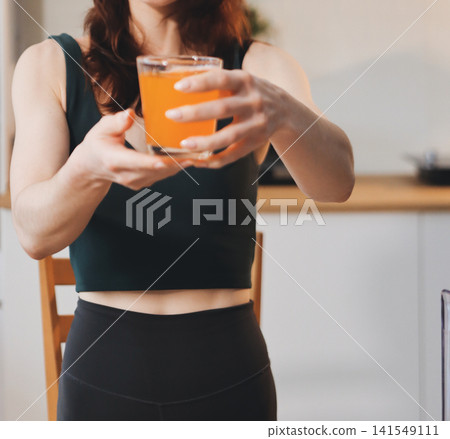 Woman preparing green smoothie in bright kitchen with fresh fruits and vegetables, healthy eating lifestyle moment in natural daylight Woman preparing green smoothie in bright kitchen with fresh fruits and vegetables, healthy eating lifestyle moment in natural daylight 141549111