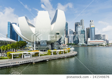 The Art Science Museum in Marina Bay, Singapore, with a skyscraper building background. The museum features exhibitions that include art, science, culture, and technology. The Art Science Museum in Marina Bay, Singapore, with a skyscraper building background. The museum features exhibitions that include art, science, culture, and technology. 141549876