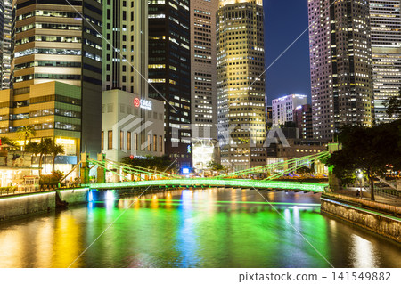 Night view of the Cavenagh Bridge with financial skyscrapers on the lower Singapore River.  141549882