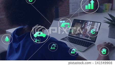 Watching curly-haired woman in blue top sitting at white desk, laptop, plant and green icons Watching curly-haired woman in blue top sitting at white desk, laptop, plant and green icons 141549908