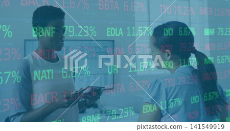 Colleagues wearing light and blue tops holding tablet, viewing stock ticker overlay in corridor Colleagues wearing light and blue tops holding tablet, viewing stock ticker overlay in corridor 141549919