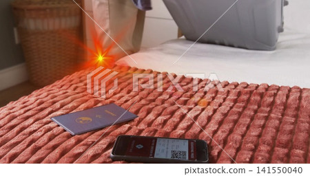 Packing khaki-pants traveler placing phone showing QR and passport on case in bedroom, copy space Packing khaki-pants traveler placing phone showing QR and passport on case in bedroom, copy space 141550040