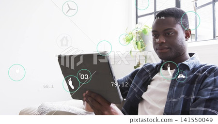 Holding tablet, adult man wearing open plaid shirt focusing on screen near window, HUD overlays Holding tablet, adult man wearing open plaid shirt focusing on screen near window, HUD overlays 141550049