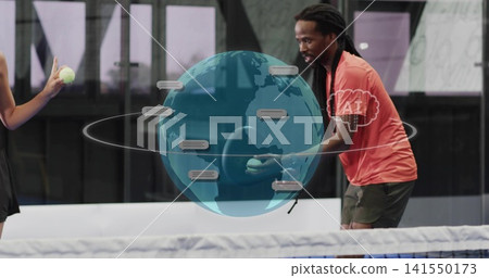 Leaning male in coral tee holding tennis balls practicing near net on enclosed court, AR globe Leaning male in coral tee holding tennis balls practicing near net on enclosed court, AR globe 141550173