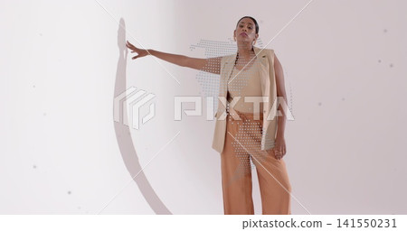 Posing woman touching wall with left-arm in studio, beige blazer, rust pants, halftone, copy space 141550231