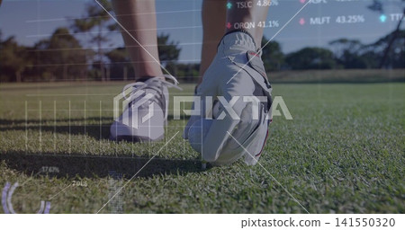 Placing golfer's gloved hand, positioning white golf ball on tee on fairway with digital overlays Placing golfer's gloved hand, positioning white golf ball on tee on fairway with digital overlays 141550320