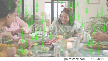 Smiling woman wearing green sweater candy-cane headband at dining table with green matrix overlay Smiling woman wearing green sweater candy-cane headband at dining table with green matrix overlay 141550495