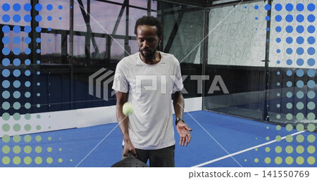 Holding paddle, mature man wearing white tee dark shorts wristwatch watching ball on blue court Holding paddle, mature man wearing white tee dark shorts wristwatch watching ball on blue court 141550769