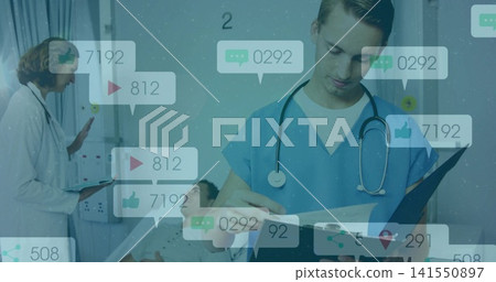 Examining clinician in blue scrubs writing chart for patient in ward with social icons, copy space Examining clinician in blue scrubs writing chart for patient in ward with social icons, copy space 141550897