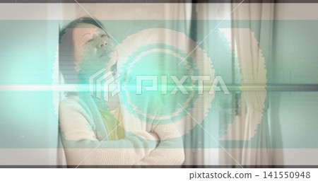 Standing senior Chinese woman crossing arms tilting upward by curtains in cardigan with teal glitch Standing senior Chinese woman crossing arms tilting upward by curtains in cardigan with teal glitch 141550948