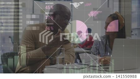 Gesturing mentor in tan sweater explaining data to woman at office round table, laptop overlay 141550988