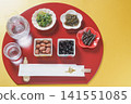 Japanese sake (chilled) and Japanese food, half-moon shaped tray and chopstick wrapper with the character for "longevity" | Gold background Japanese sake (chilled) and Japanese food, half-moon shaped tray and chopstick wrapper with the character for "longevity" | Gold background 141551085