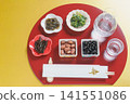 Japanese sake (chilled) and Japanese food, half-moon shaped tray and chopstick wrapper with the character for "longevity" | Gold background Japanese sake (chilled) and Japanese food, half-moon shaped tray and chopstick wrapper with the character for "longevity" | Gold background 141551086