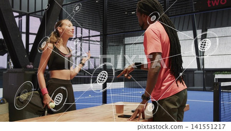Talking pair leaning on wooden courtside table at blue court, woman in black sportswear, AR overlay Talking pair leaning on wooden courtside table at blue court, woman in black sportswear, AR overlay 141551217