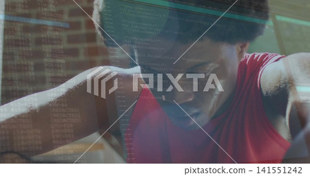 Leaning man in red sleeveless top resting forearms studying code in studio, terminal overlay Leaning man in red sleeveless top resting forearms studying code in studio, terminal overlay 141551242