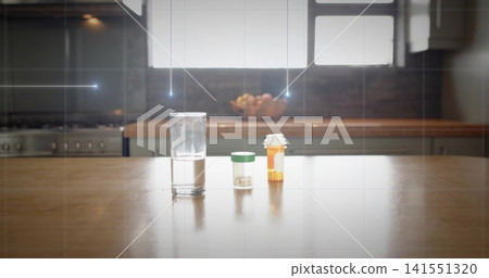 Displaying three containers sitting on home kitchen island, water glass, pill vial, amber bottle Displaying three containers sitting on home kitchen island, water glass, pill vial, amber bottle 141551320